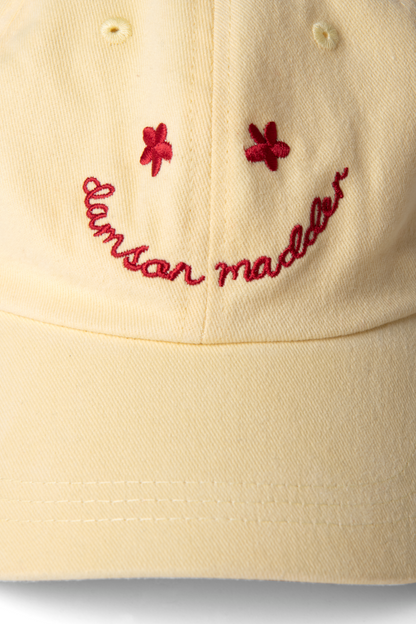 washed smiley cap in butter with red embroidery