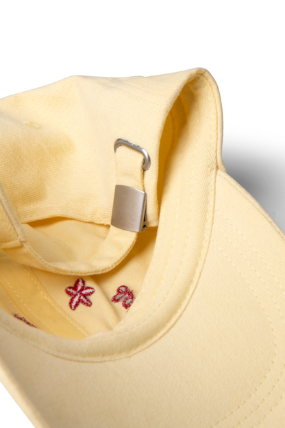washed smiley cap in butter with red embroidery